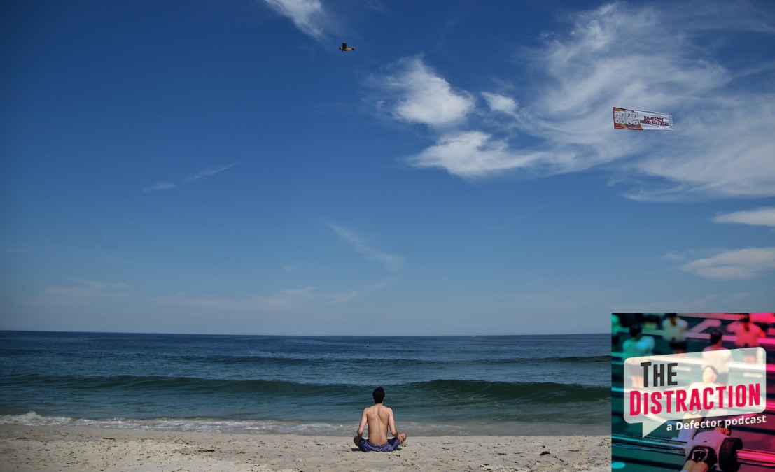 A man sitting on a beach at the Jersey Shore in 2020. He's got a lot of space, which is how you know the photo was from 2020.
