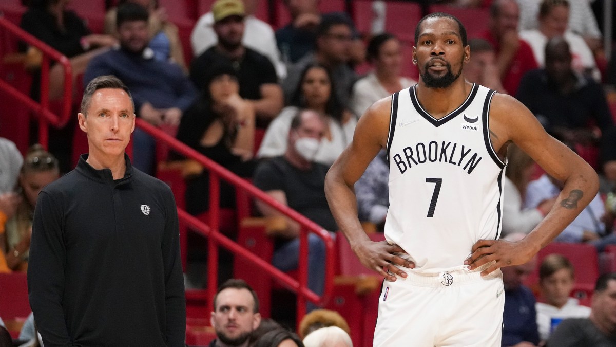 Kevin Durant and Steve Nash stand on the sideline of a Nets game.