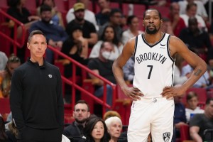 Kevin Durant and Steve Nash stand on the sideline of a Nets game.
