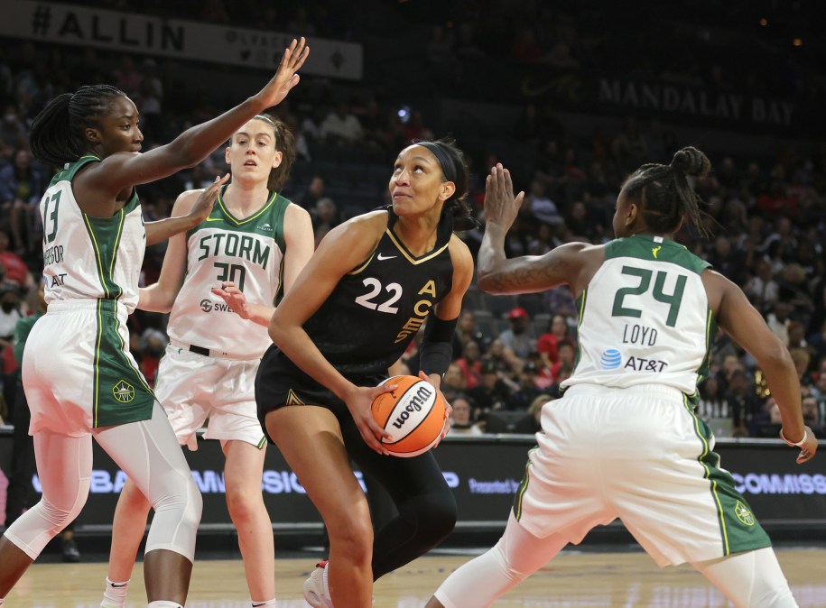 LAS VEGAS, NEVADA - MAY 08: A'ja Wilson #22 of the Las Vegas Aces is guarded by Ezi Magbegor #13, Breanna Stewart #30 and Jewell Loyd #24of the Seattle Storm during their game at Michelob ULTRA Arena on May 08, 2022 in Las Vegas, Nevada. The Aces defeated the Storm 85-74. NOTE TO USER: User expressly acknowledges and agrees that, by downloading and or using this photograph, User is consenting to the terms and conditions of the Getty Images License Agreement.