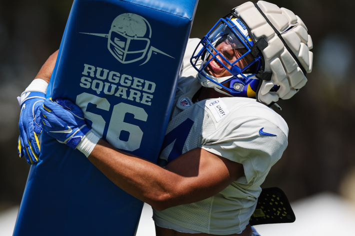 A Los Angeles Ram, wearing the helmet helmet and tackling a tackling dummy