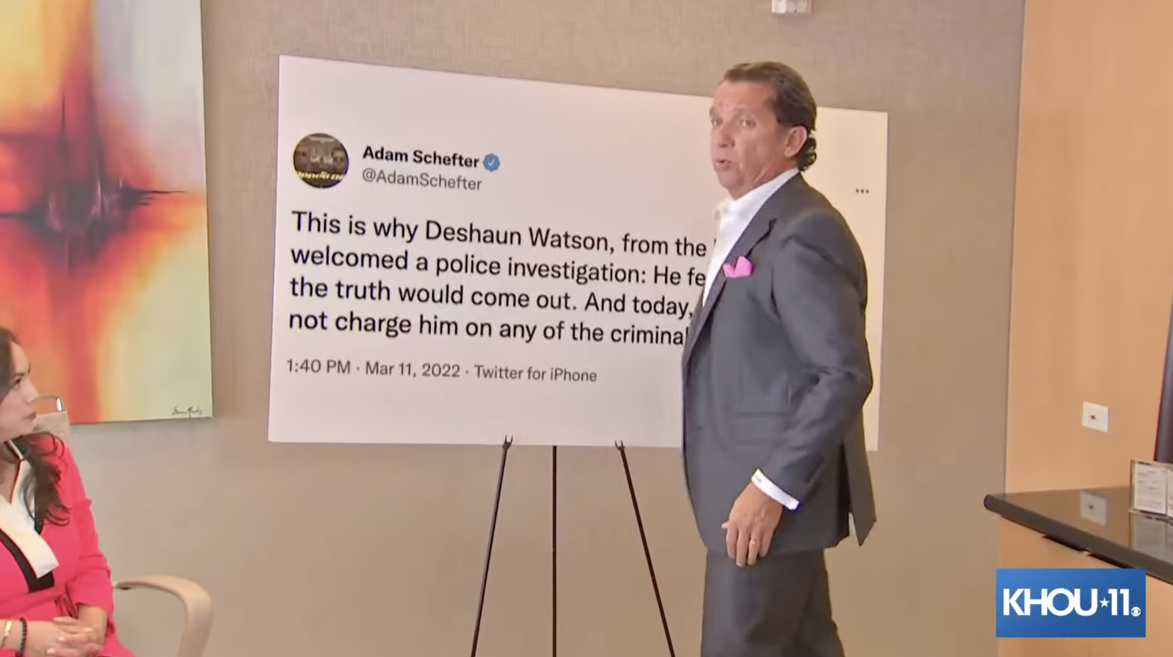 A photo of lawyer Tony Buzbee unveiling a giant blow up of a Adam Schefter tweet. The tweet reads: "This is why Deshaun Watson, from the beginning, welcomed a police investigation: He felt he knew that the truth would come out. And today, a grand jury did not charge him on any of the criminal complaints."
