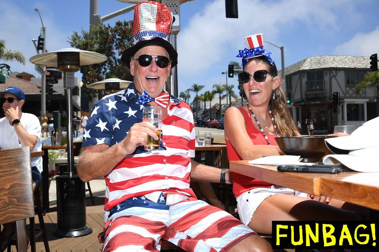 TOPSHOT - Dave Barnes enjoys a holiday lunch with his wife Christy Barnes at an outdoor restaurant in Manhattan Beach, California where beaches are closed due to a spike in COVID-19 in Los Angeles County, on July 4, 2020, the US Independence Day holiday. - Beaches and indoor restaurant seating in Los Angeles County are closed to help fight the spread of the coronavirus pandemic. (Photo by Robyn Beck / AFP) (Photo by ROBYN BECK/AFP via Getty Images)