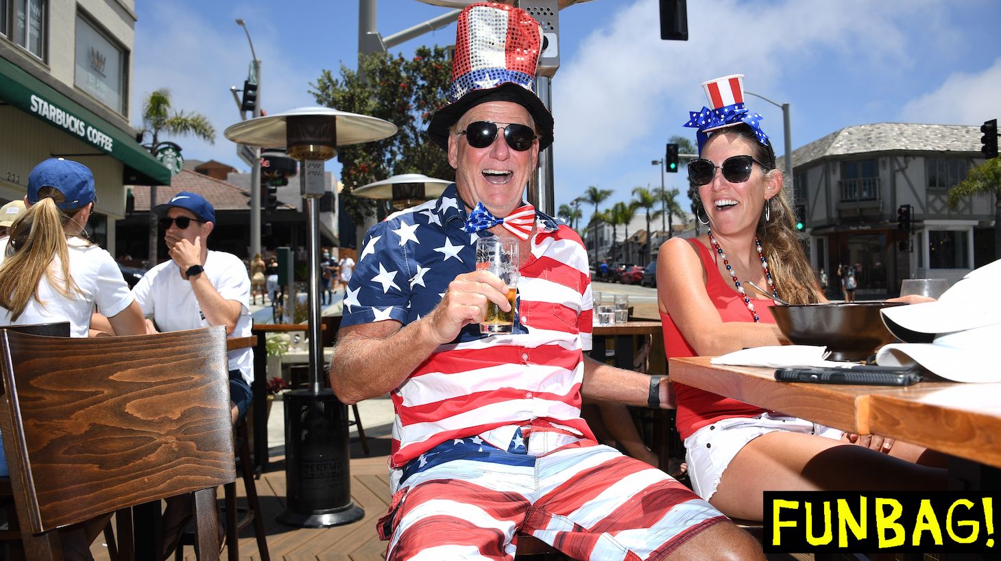 TOPSHOT - Dave Barnes enjoys a holiday lunch with his wife Christy Barnes at an outdoor restaurant in Manhattan Beach, California where beaches are closed due to a spike in COVID-19 in Los Angeles County, on July 4, 2020, the US Independence Day holiday. - Beaches and indoor restaurant seating in Los Angeles County are closed to help fight the spread of the coronavirus pandemic. (Photo by Robyn Beck / AFP) (Photo by ROBYN BECK/AFP via Getty Images)