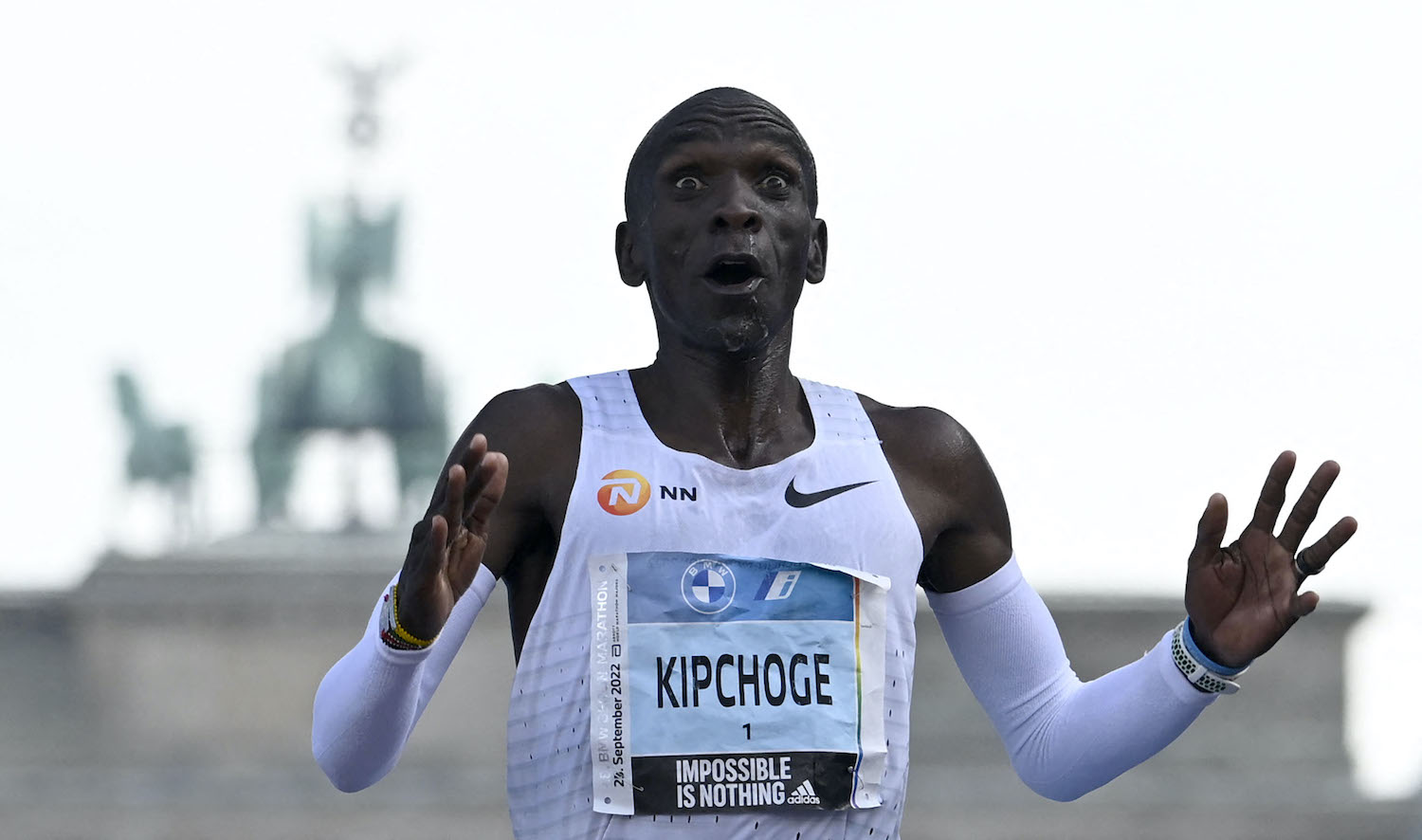 TOPSHOT - Kenya's Eliud Kipchoge crosses the finish line to win the Berlin Marathon race on September 25, 2022 in Berlin. - Kipchoge has beaten his own world record by 30 seconds, running 2:01:09 at the Berlin Marathon. (Photo by Tobias SCHWARZ / AFP)