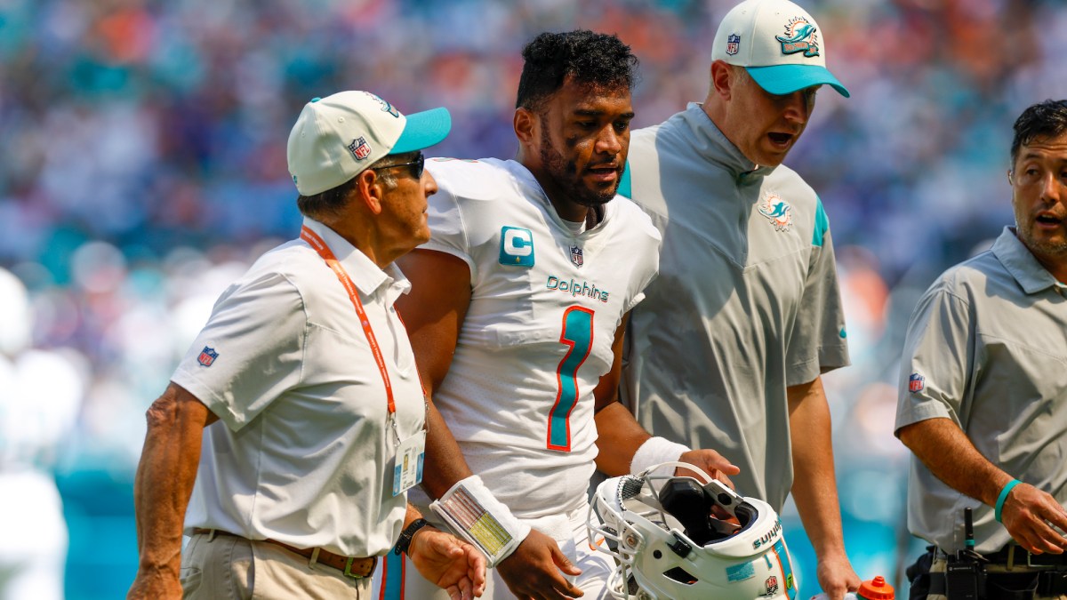 MIAMI GARDENS, FL - SEPTEMBER 25: Miami Dolphins quarterback Tua Tagovailoa (1) walks off the field with trainers following a play during the game between the Buffalo Bills and the Miami Dolphins on September 25, 2022 at Hard Rock Stadium in Miami Gardens, Fl. (Photo by David Rosenblum/Icon Sportswire via Getty Images)