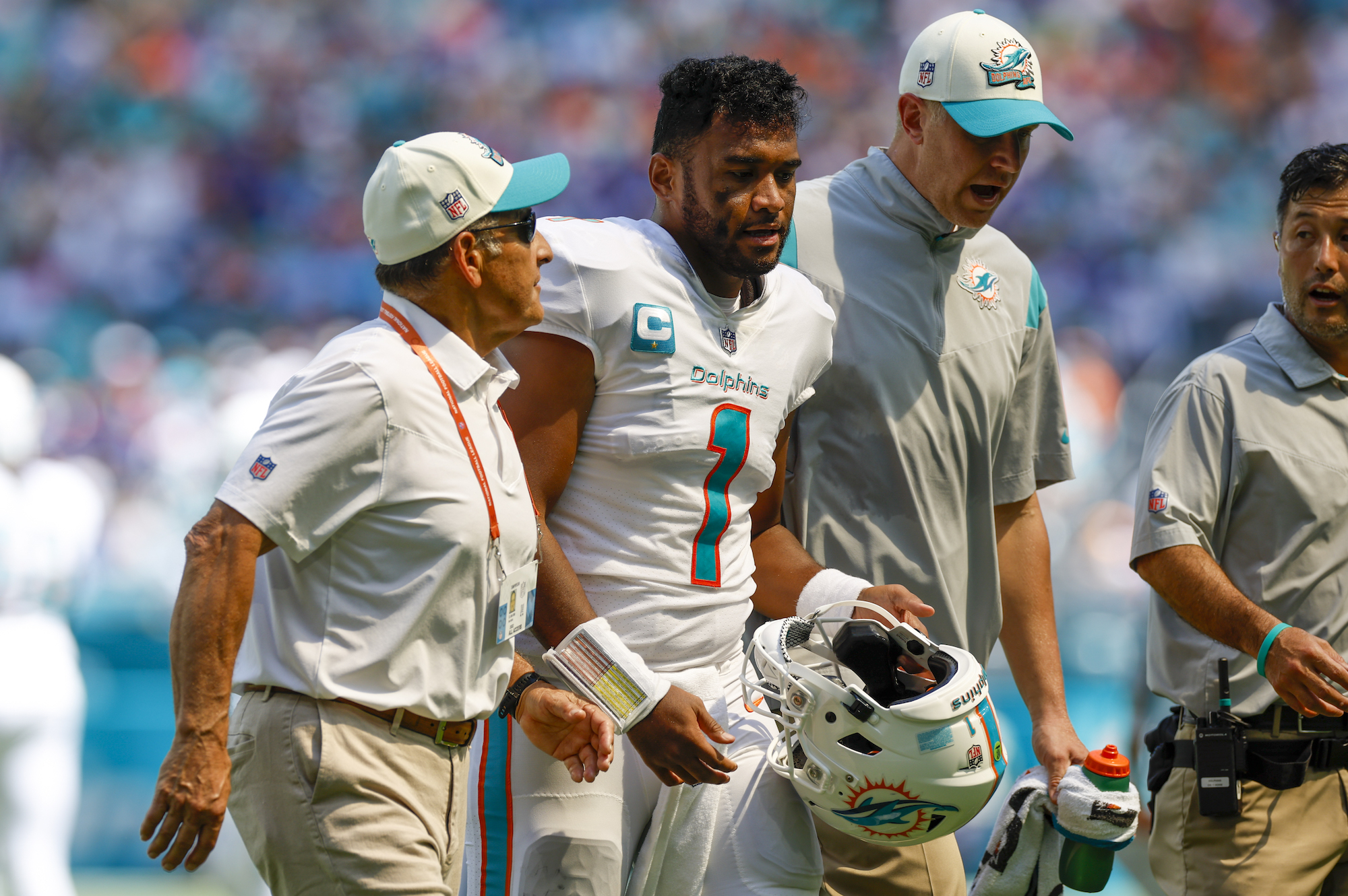 MIAMI GARDENS, FL - SEPTEMBER 25: Miami Dolphins quarterback Tua Tagovailoa (1) walks off the field with trainers following a play during the game between the Buffalo Bills and the Miami Dolphins on September 25, 2022 at Hard Rock Stadium in Miami Gardens, Fl. (Photo by David Rosenblum/Icon Sportswire via Getty Images)