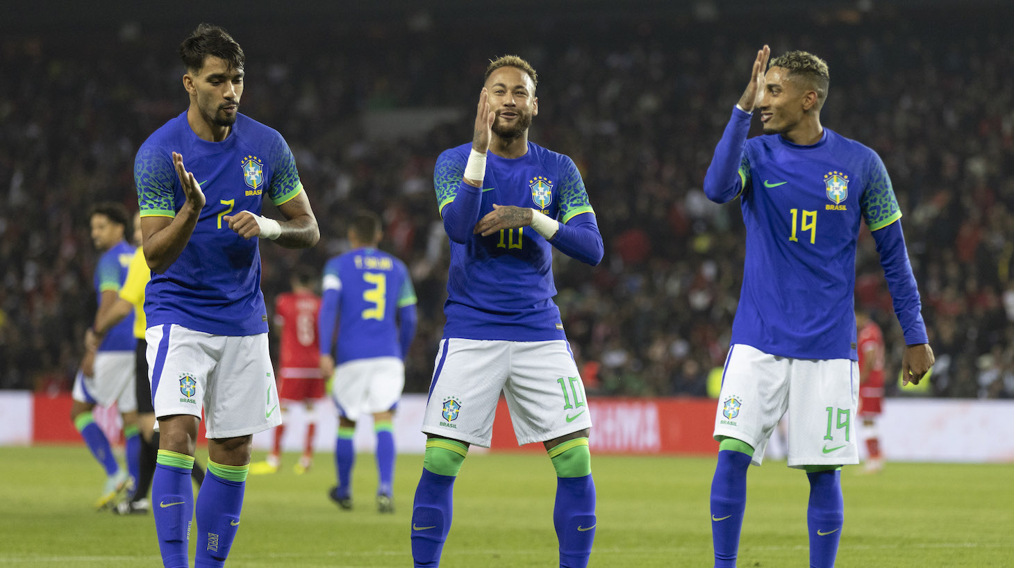 Neymar Jr of Brazil celebrates after scoring their side's third goal with his teammates Raphinha and Lucas Paqueta during the international friendly match between Brazil and Tunisia at Parc des Princes on September 27, 2022 in Paris, France.