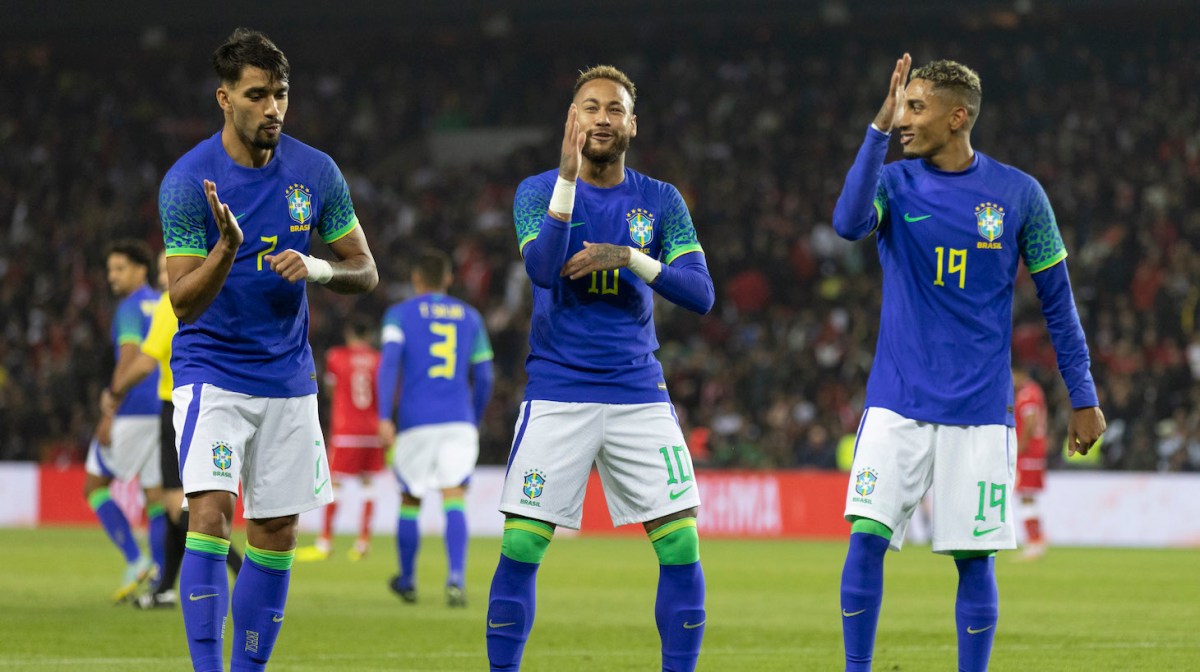 Neymar Jr of Brazil celebrates after scoring their side's third goal with his teammates Raphinha and Lucas Paqueta during the international friendly match between Brazil and Tunisia at Parc des Princes on September 27, 2022 in Paris, France.