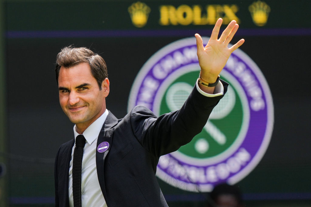 Roger Federer waves to the crowd at Wimbledon.