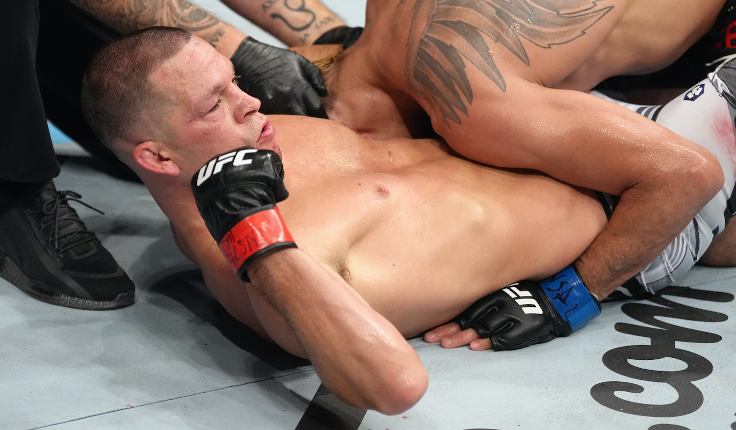 Nate Diaz flexes during his fight against Tony Ferguson at UFC 279.
