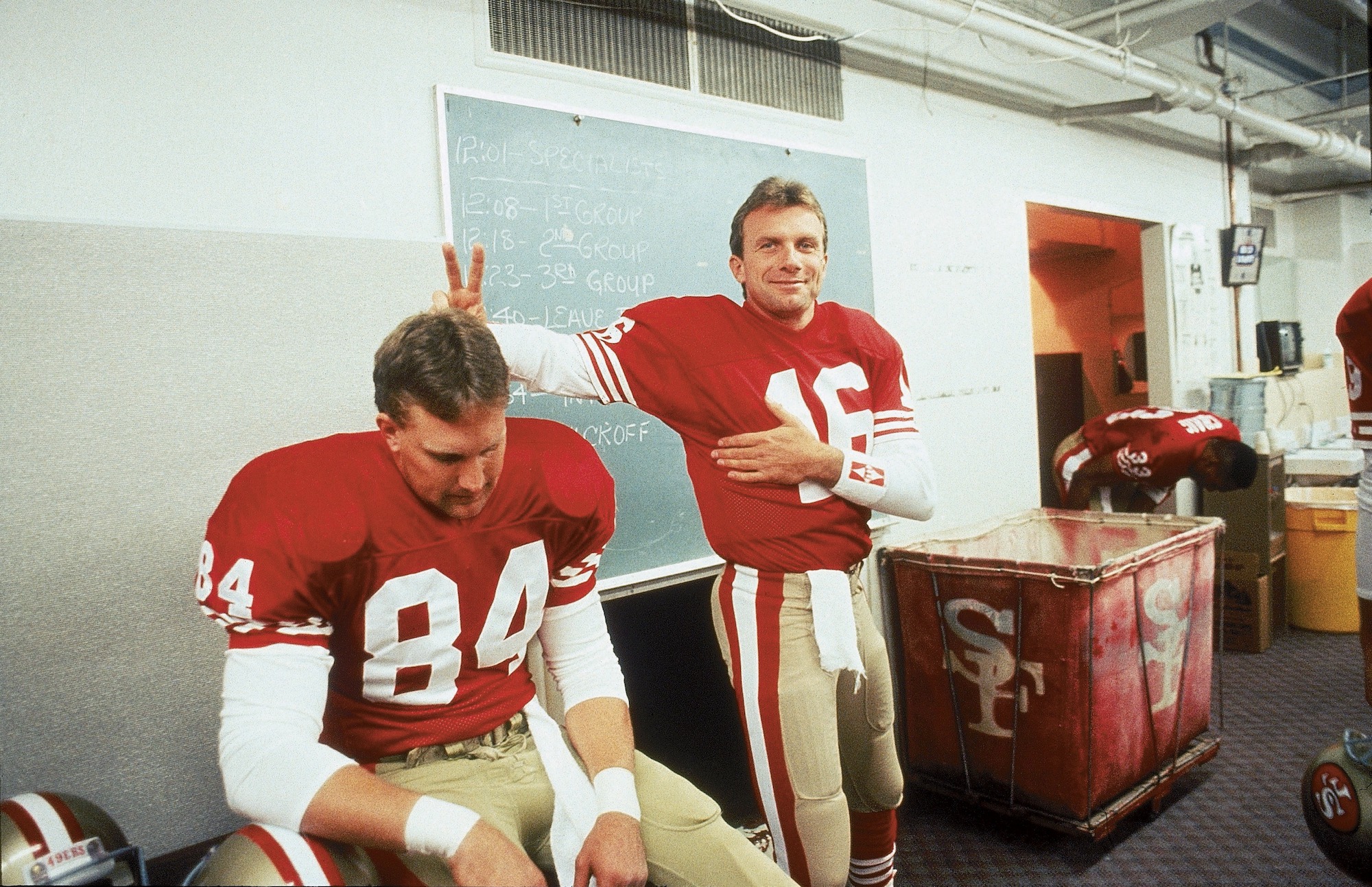 UNITED STATES - NOVEMBER 01: Football: San Francisco 49ers QB Joe Montana (16) gesturing bunny ears with Brent Jones (84) in locker room before game, San Francisco, CA 11/18/1990--11/25/1990 (Photo by Michael Zagaris/Sports Illustrated via Getty Images) (SetNumber: D52377)