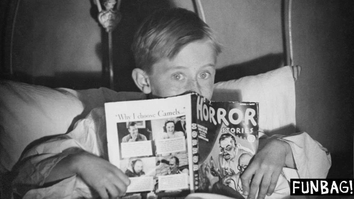 A boy in bed with a copy of 'Horror Stories' comic book, circa 1960. (Photo by Hunter/FPG/Hulton Archive/Getty Images)