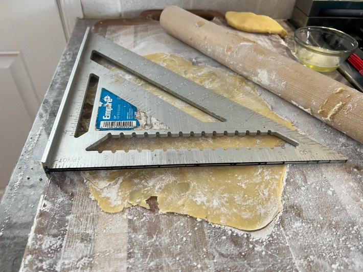 Measuring dough with a carpenter's triangle.