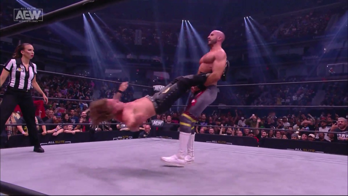 Claudio Castagnoli swings Chris Jericho on AEW Dynamite. Ref Aubrey Edwards is behind him.