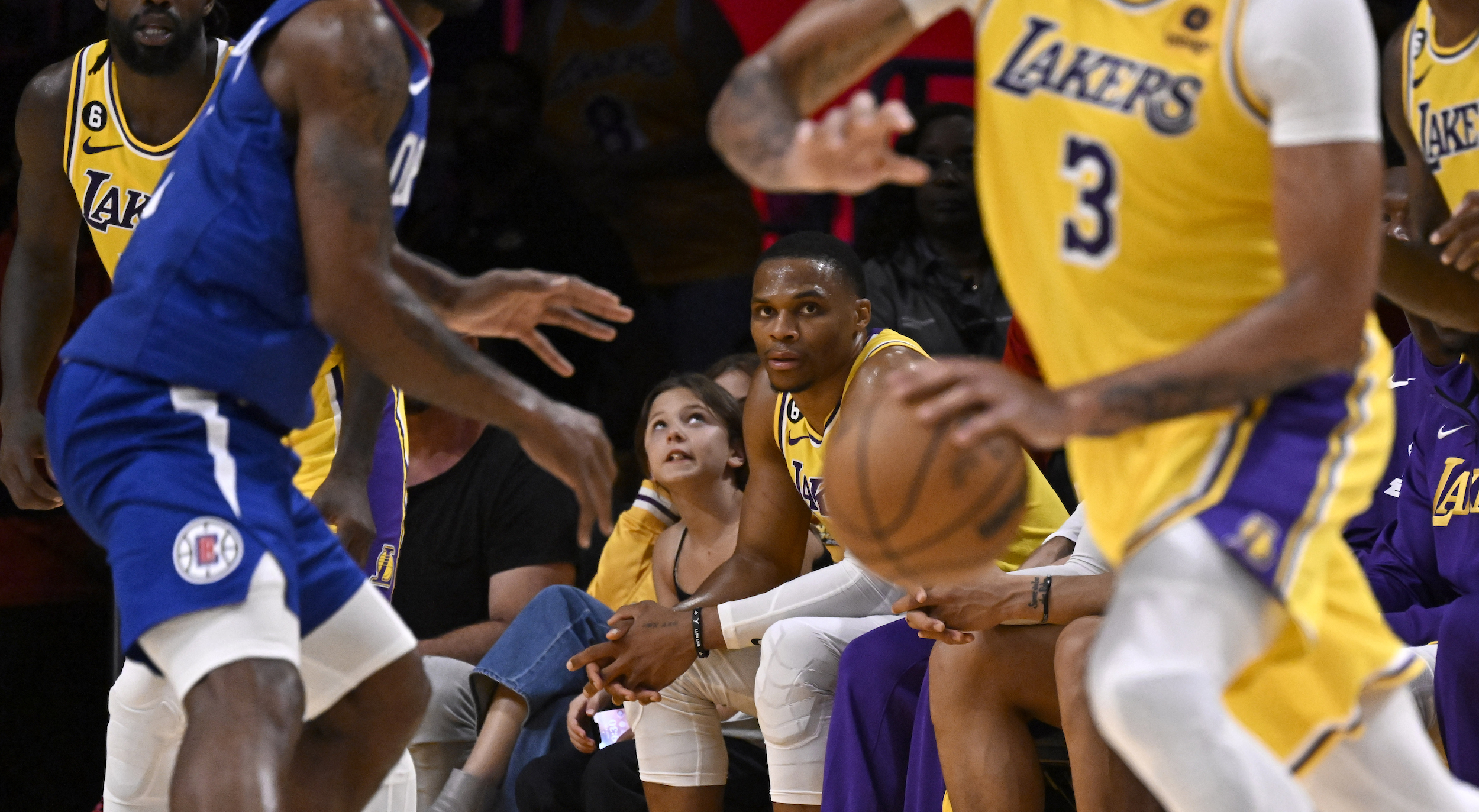 Russell Westbrook watches from the bench.