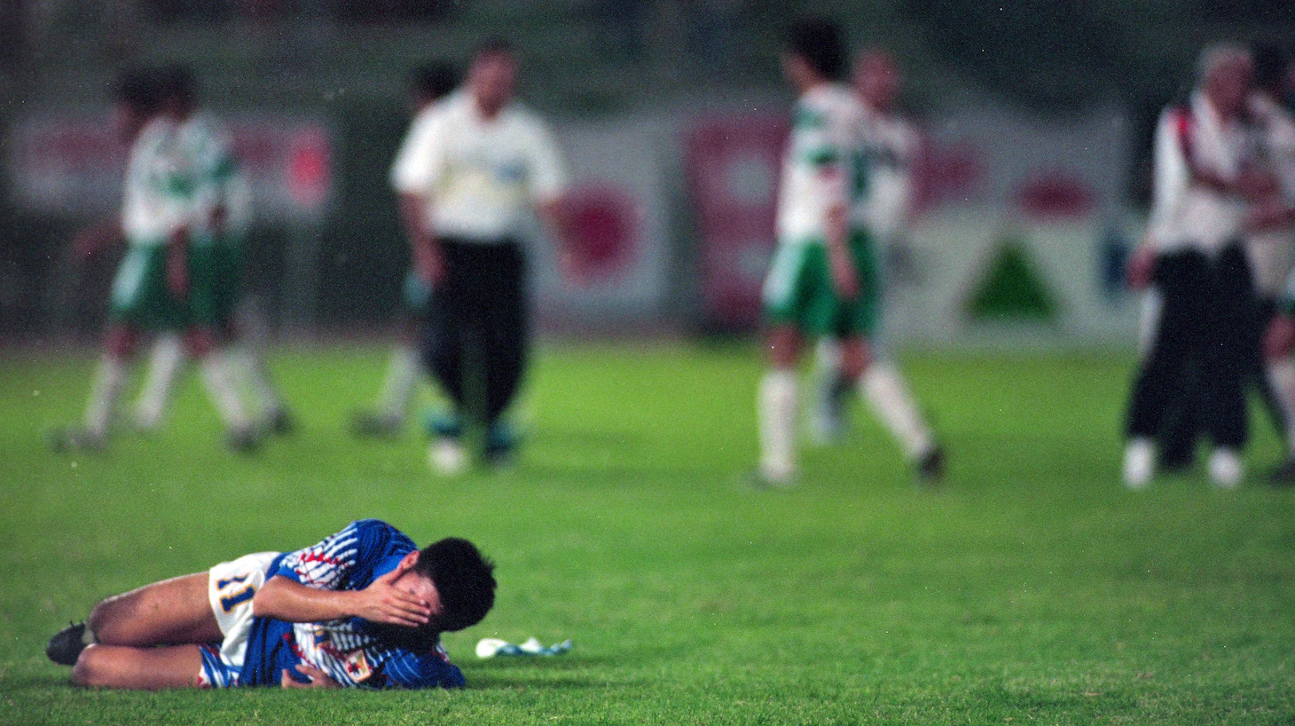 Kazuyoshi Miura of Japan falls after the FIFA World Cup Asian Qualifier final round match between Iraq and Japan at the Al-Ahly Stadium on October 28, 1993 in Doha, Qatar.