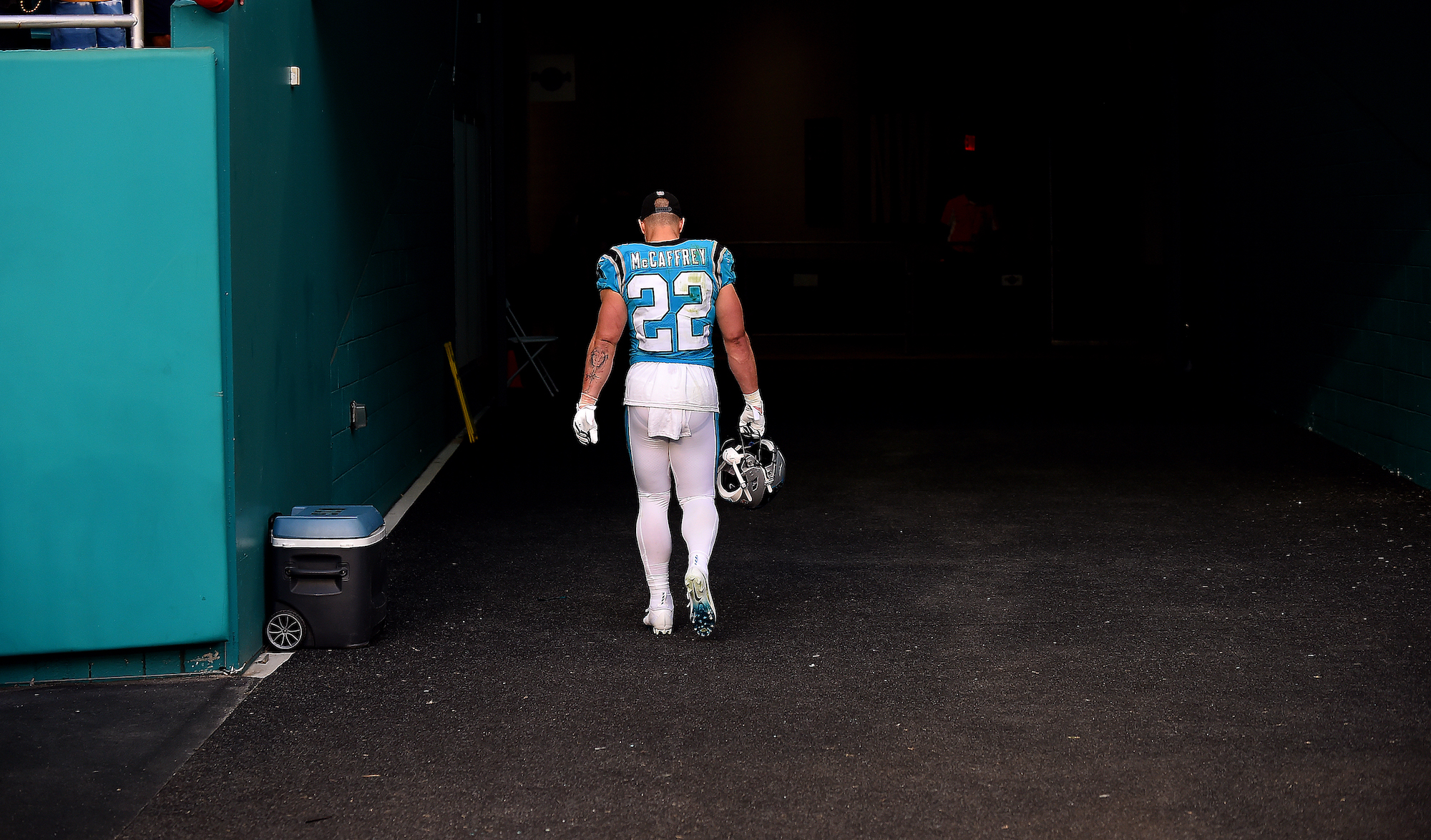 MIAMI GARDENS, FLORIDA - NOVEMBER 28: Christian McCaffrey #22 of the Carolina Panthers walks back to the locker room after Carolina was defeated by Miami 33-10 at Hard Rock Stadium on November 28, 2021 in Miami Gardens, Florida. (Photo by Eric Espada/Getty Images)