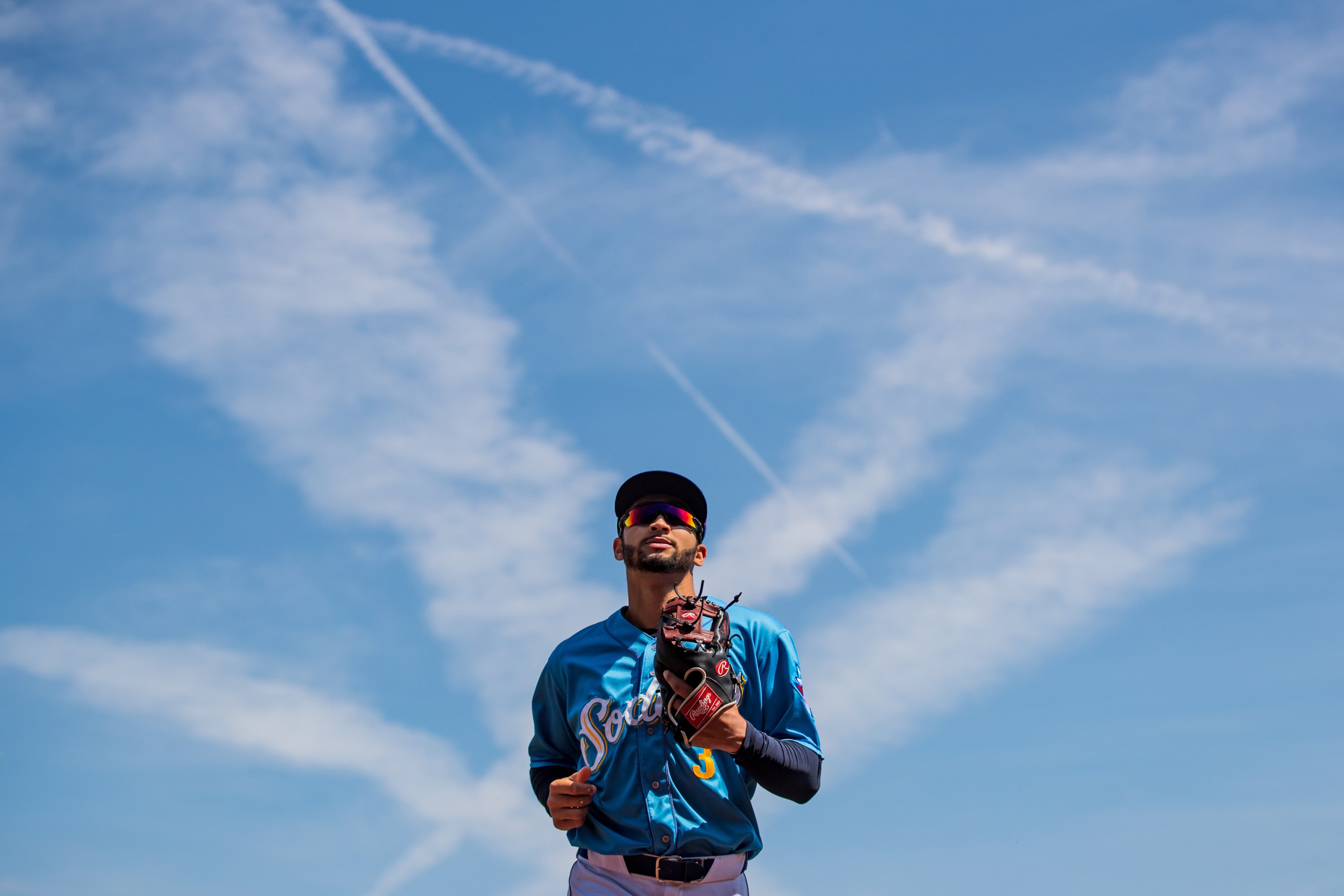 Amarillo Sod Poodles infielder Jordan Lawlar seen outlined against a bright blue sky in a game against the Frisco RoughRiders in September of 2022.