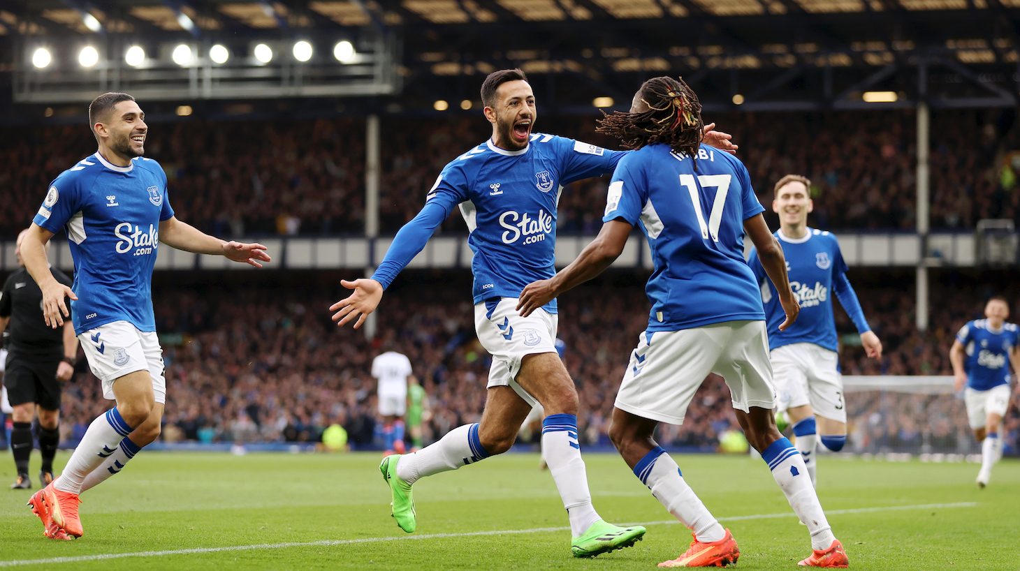 Dwight McNeil of Everton celebrates with teammate Alex Iwobi after scoring their team's third goal during the Premier League match between Everton FC and Crystal Palace at Goodison Park on October 22, 2022 in Liverpool, England.
