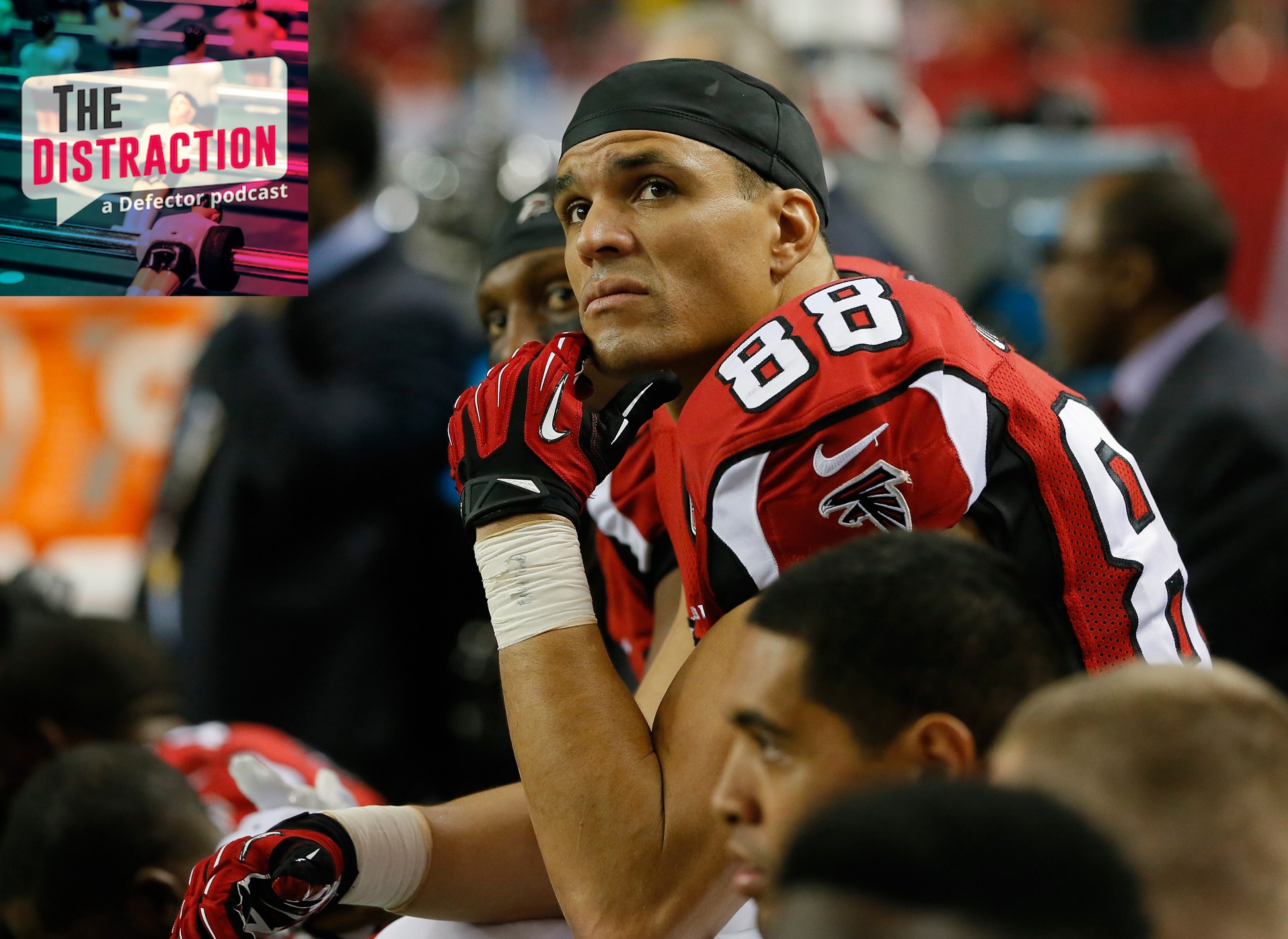 Tony Gonzalez looking at the Distraction logo, in uniform during his Atlanta Falcons years.