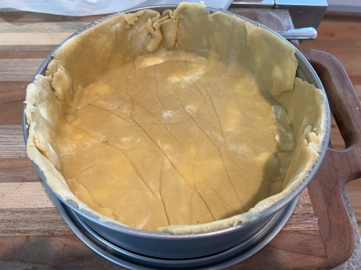 Raw dough spread in a pie tin.