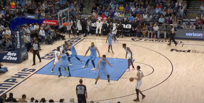 Four of five Grizzlies defenders packed around the paint, ignoring Ben Simmons at the three-point line