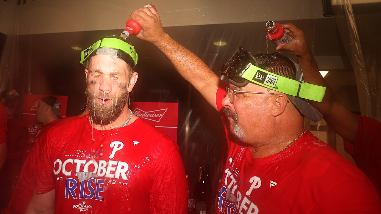 A Phillies employee pours beer over Bryce Harper's head