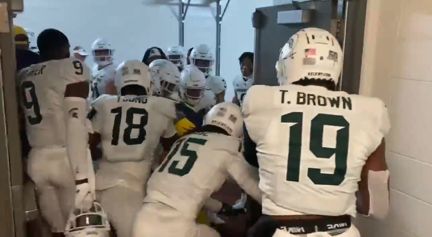 Michigan State players fight Michigan cornerback Ja'Den McBurrows in the tunnel after Saturday's game.