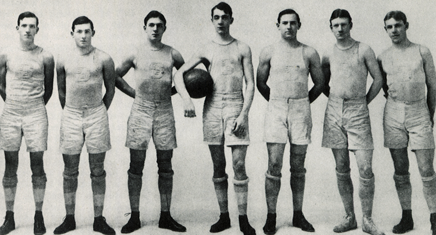 Seven old-timey hoopers in white outfits and high socks
