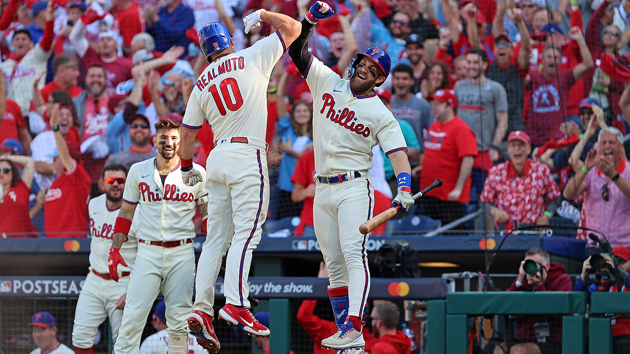 PHILADELPHIA, PENNSYLVANIA - OCTOBER 15: J.T. Realmuto #10 of the Philadelphia Phillies is congratulated by Bryce Harper #3 following an in the park home run against the Atlanta Braves during the third inning in game four of the National League Division Series at Citizens Bank Park on October 15, 2022 in Philadelphia, Pennsylvania.