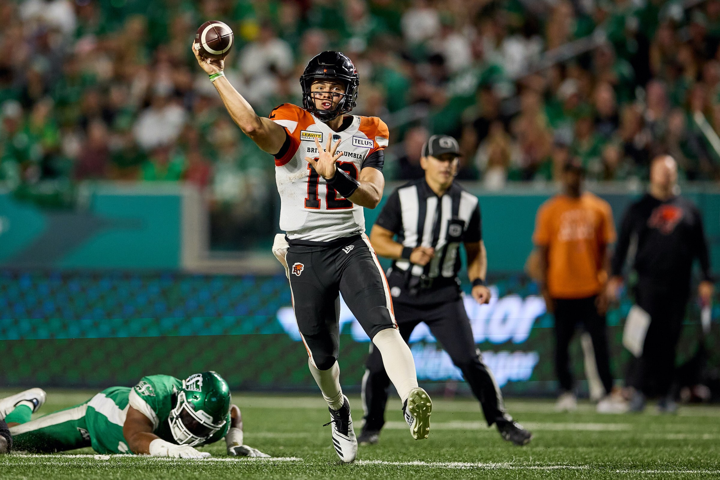 REGINA, SK - AUGUST 19: Nathan Rourke #12 of the BC Lions throws on the run in the first half of the game between the BC Lions and Saskatchewan Roughriders at Mosaic Stadium on August 19, 2022 in Regina, Canada. (Photo by Brent Just/Getty Images)