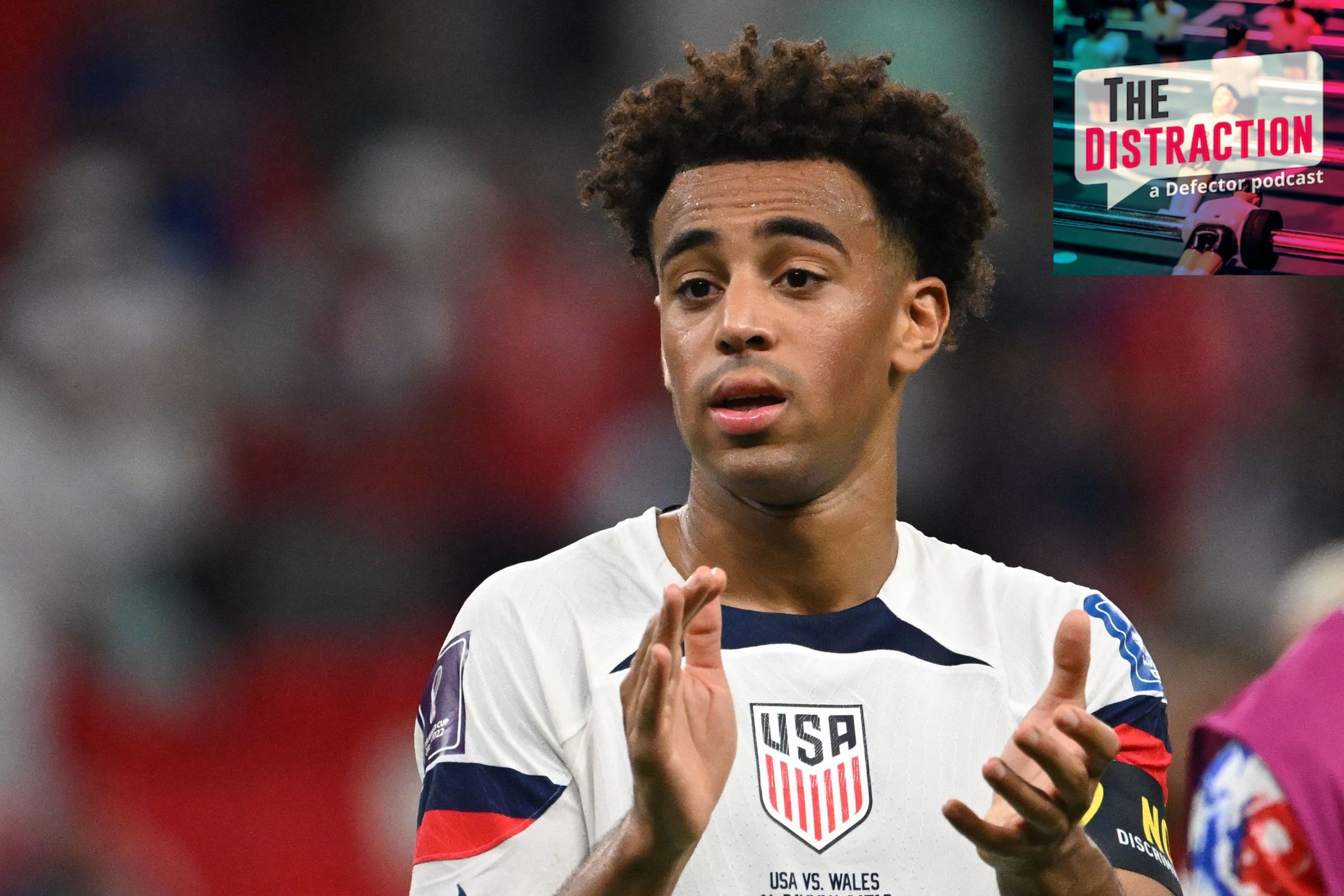 USMNT midfielder Tyler Adams applauds after the team's 1-1 tie against Wales in the 2022 World Cup. The Distraction logo is at upper right.