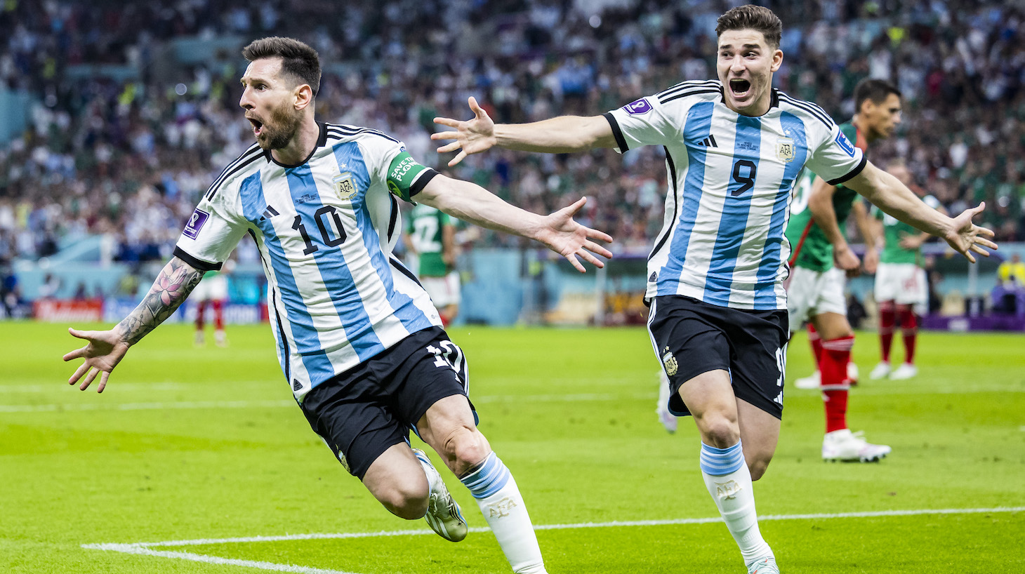 Argentina's Lionel Messi (l) cheers with Argentina's Julian Alvarez (r) after his goal for 1:0.