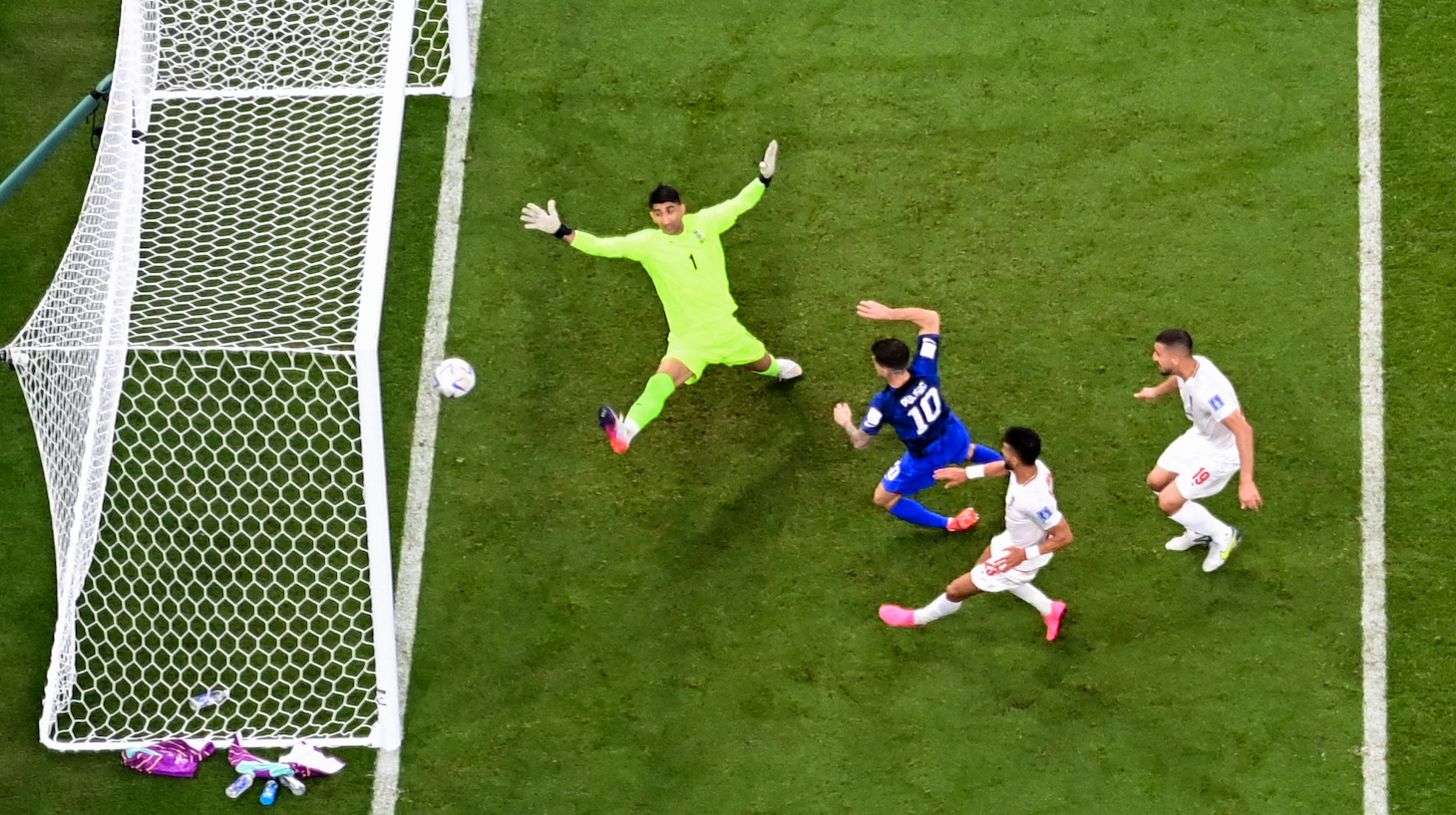 USA's forward #10 Christian Pulisic scores his team's first goal past Iran's goalkeeper #01 Alireza Beiranvand during the Qatar 2022 World Cup Group B football match between Iran and USA at the Al-Thumama Stadium in Doha on November 29, 2022.