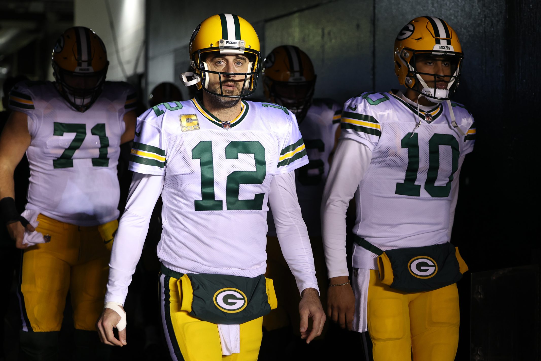 Aaron Rodgers and Jordan Love walk to the field