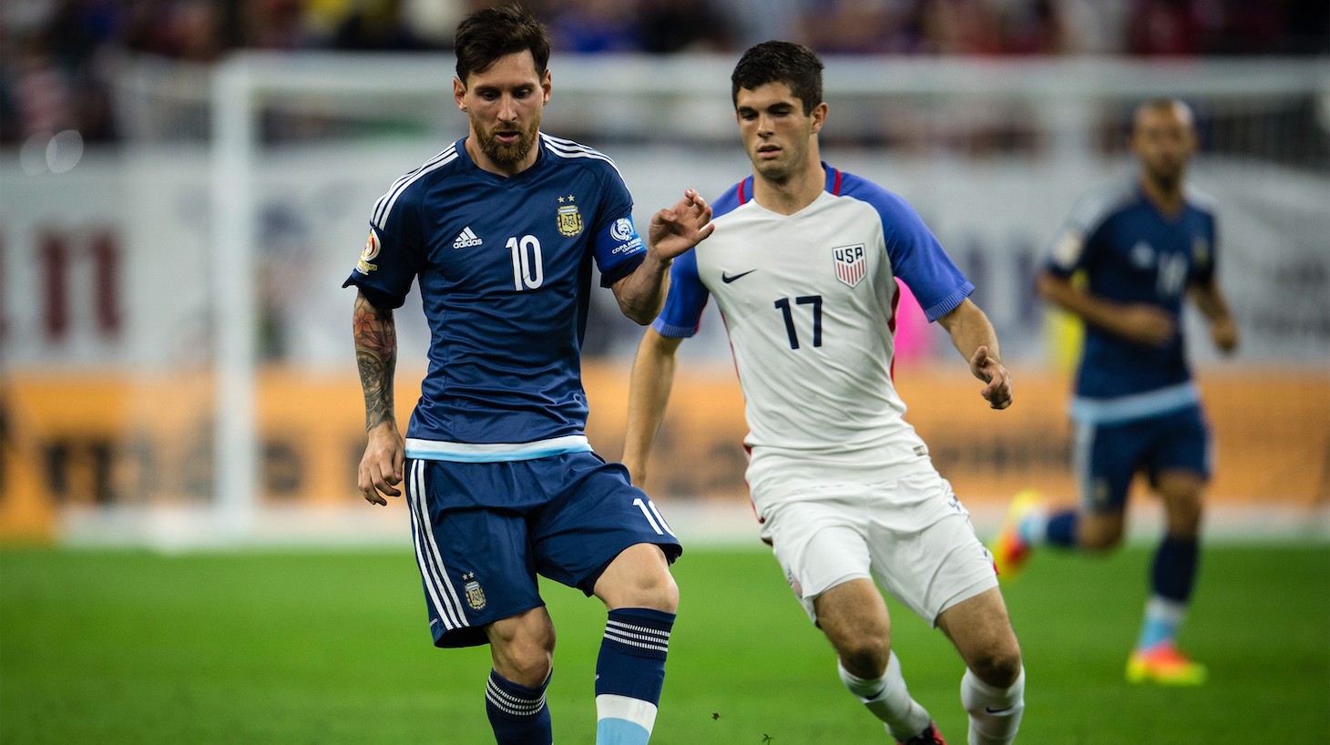 Christian Pulisic (R) of USA struggle for the ball against Lionel Messi (L) of Argentina during the 2016 Copa America Centenario Semi-final match between USA vs Argentina at the NRG Stadium on June 21, 2016 in Houston, USA.