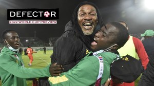 Cameroon's coach Rigobert Song (C) celebrates with his coaching staff after qualifying for the 2022 Qatar World Cup African after winning the football match between Algeria and Cameroon at the Mustapha Tchaker Stadium in the city of Blida on March 29, 2022.
