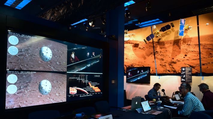 People watch the landing of NASA's InSight spacecraft on the planet Mars on television screens at NASA's Jet Propulsion Laboratory (JPL) in Pasadena, California on November 26, 2018. - Cheers and applause erupted at NASA's Jet Propulsion Laboratory as a $993 million unmanned lander, called InSight, touched down on the Red Planet and managed to send back its first picture. (Photo by Frederic J. BROWN / AFP) (Photo credit should read FREDERIC J. BROWN/AFP via Getty Images)