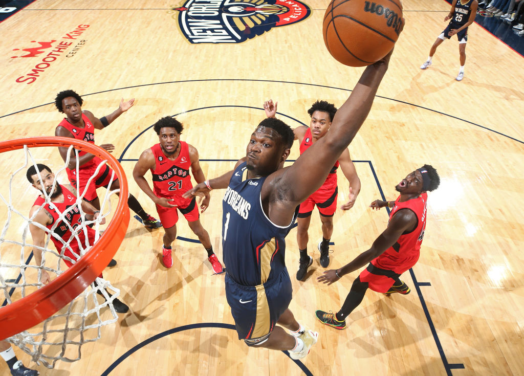 Zion Williamson dunks as an entire Toronto Raptors squad looks on.
