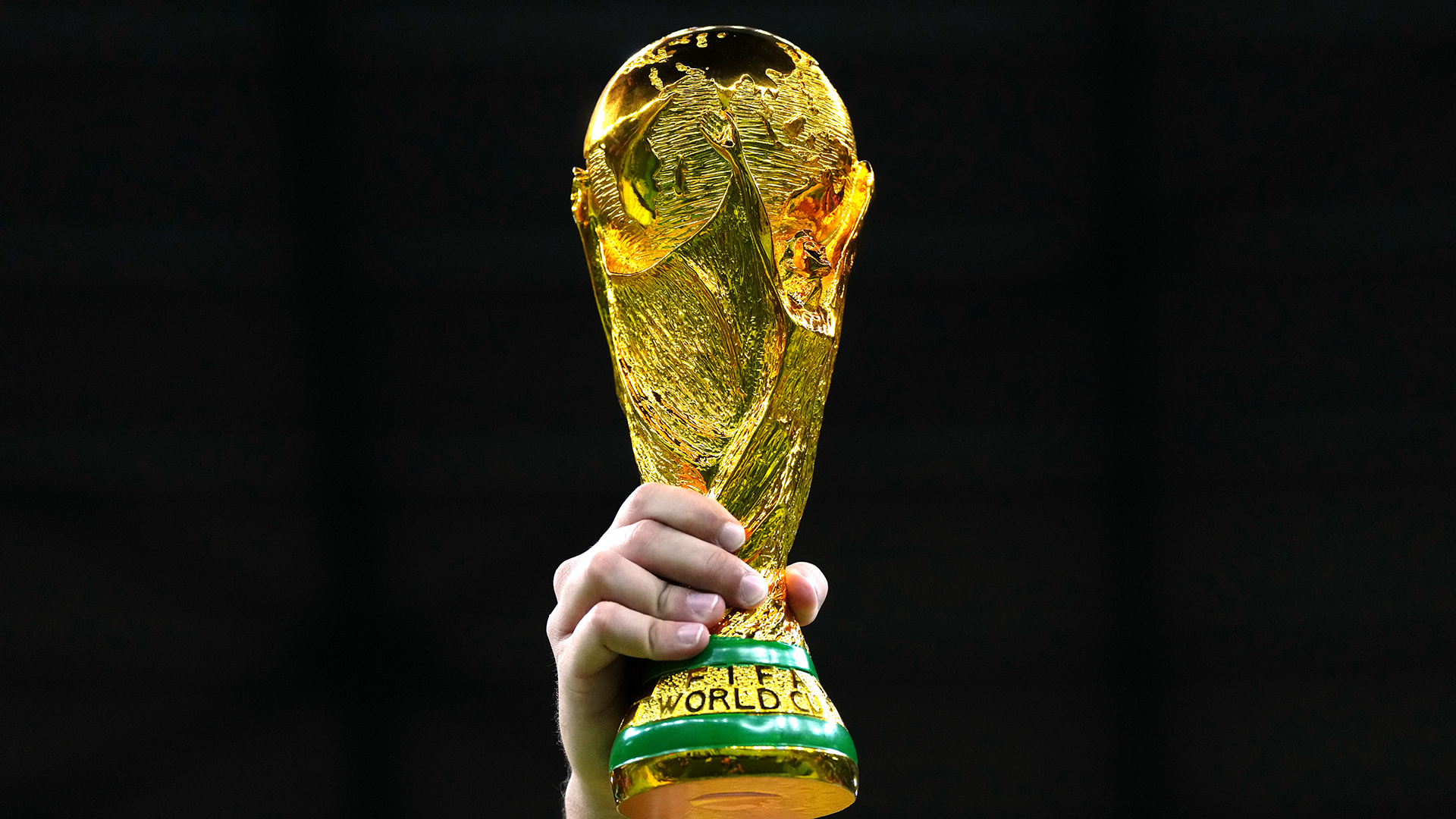 A fan in the stands holds aloft a replica World Cup trophy during the FIFA World Cup Quarter-Final match at the Education City Stadium in Al Rayyan, Qatar. Picture date: Friday December 9, 2022.