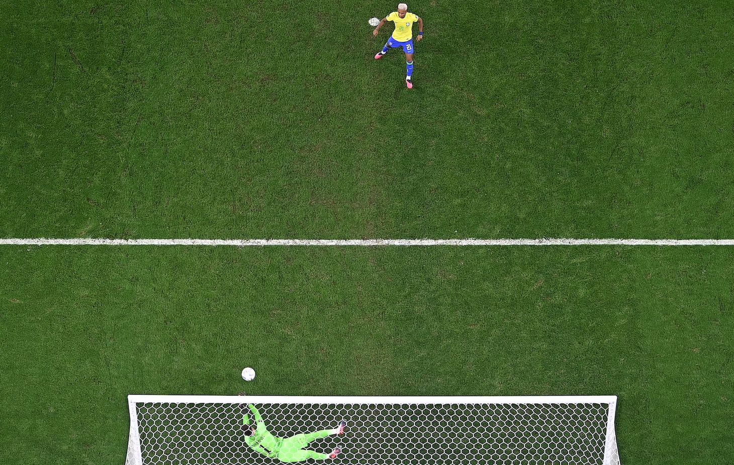 Croatia's goalkeeper #01 Dominik Livakovic deflects a shot from Brazil's forward #21 Rodrygo during a penalty shootout during the Qatar 2022 World Cup quarter-final football match between Croatia and Brazil at Education City Stadium in Al-Rayyan, west of Doha, on December 9, 2022.