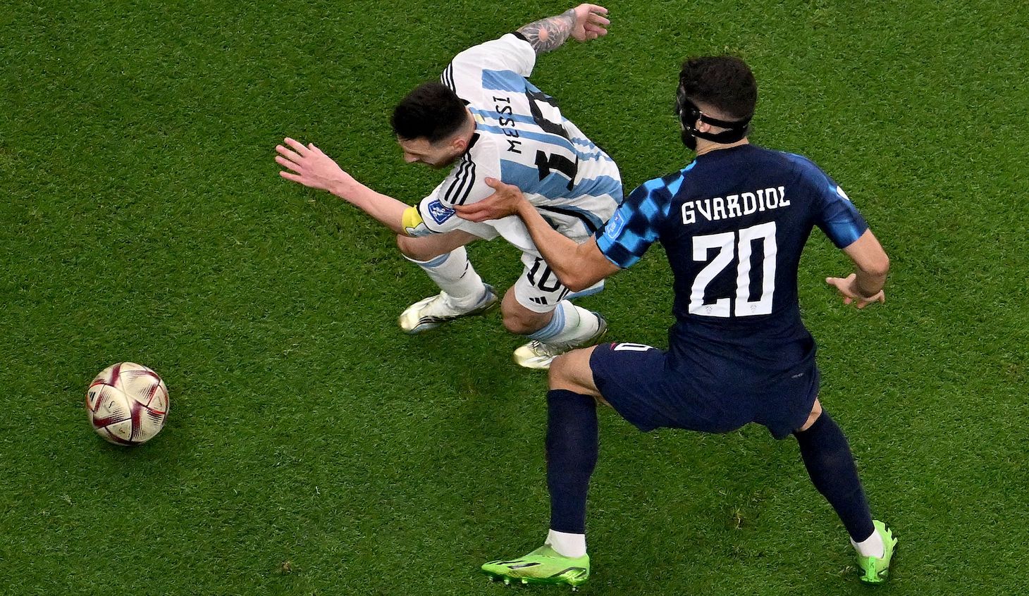 Argentina's forward #10 Lionel Messi outpasses Croatia's defender #20 Josko Gvardiol during the Qatar 2022 World Cup football semi-final match between Argentina and Croatia at Lusail Stadium in Lusail, north of Doha on December 13, 2022.
