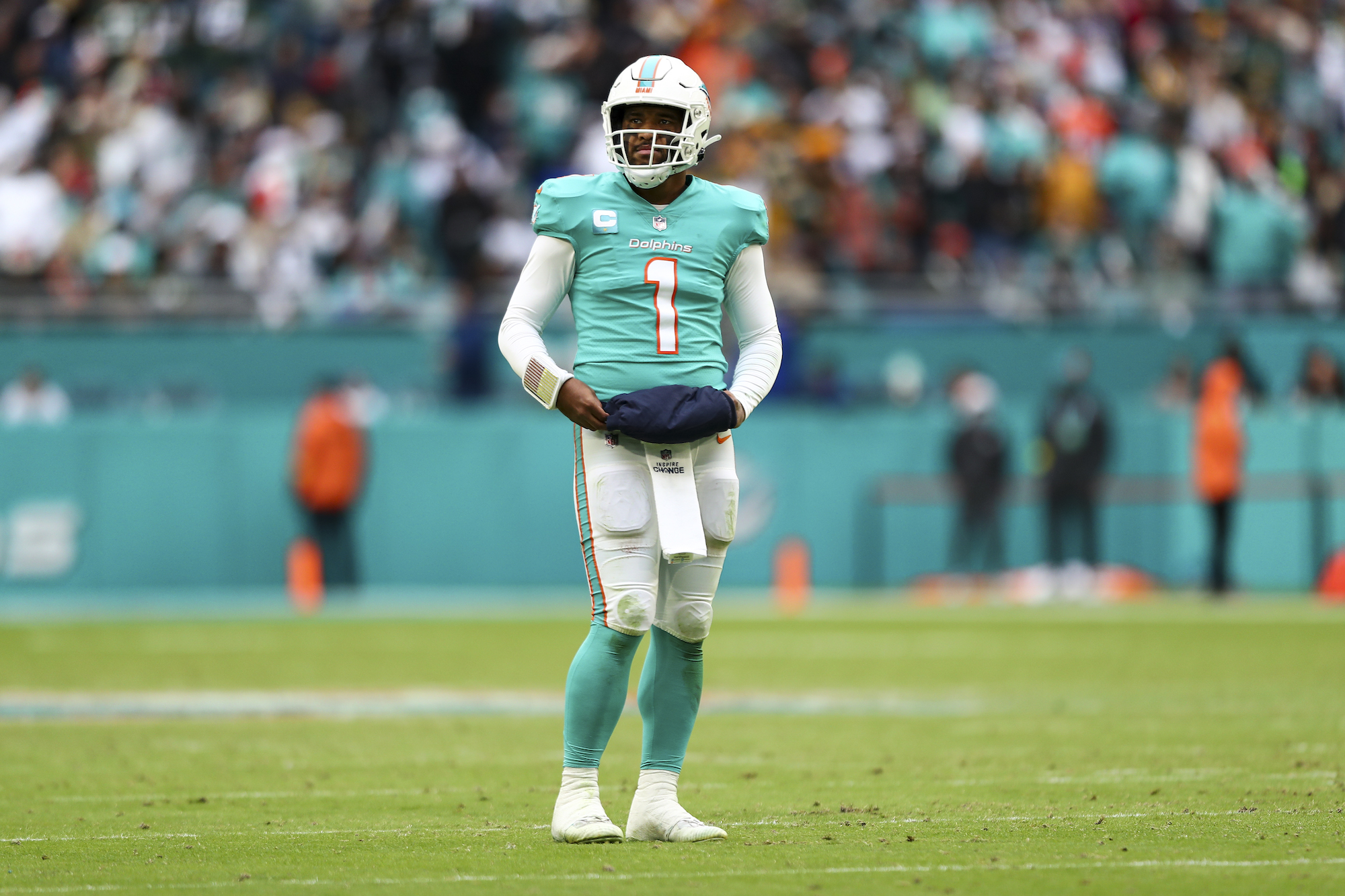 MIAMI GARDENS, FL - DECEMBER 25: Tua Tagovailoa #1 of the Miami Dolphins looks to the sidelines before a play during the fourth quarter of an NFL football game against the Green Bay Packers at Hard Rock Stadium on December 25, 2022 in Miami Gardens, Florida. (Photo by Kevin Sabitus/Getty Images)