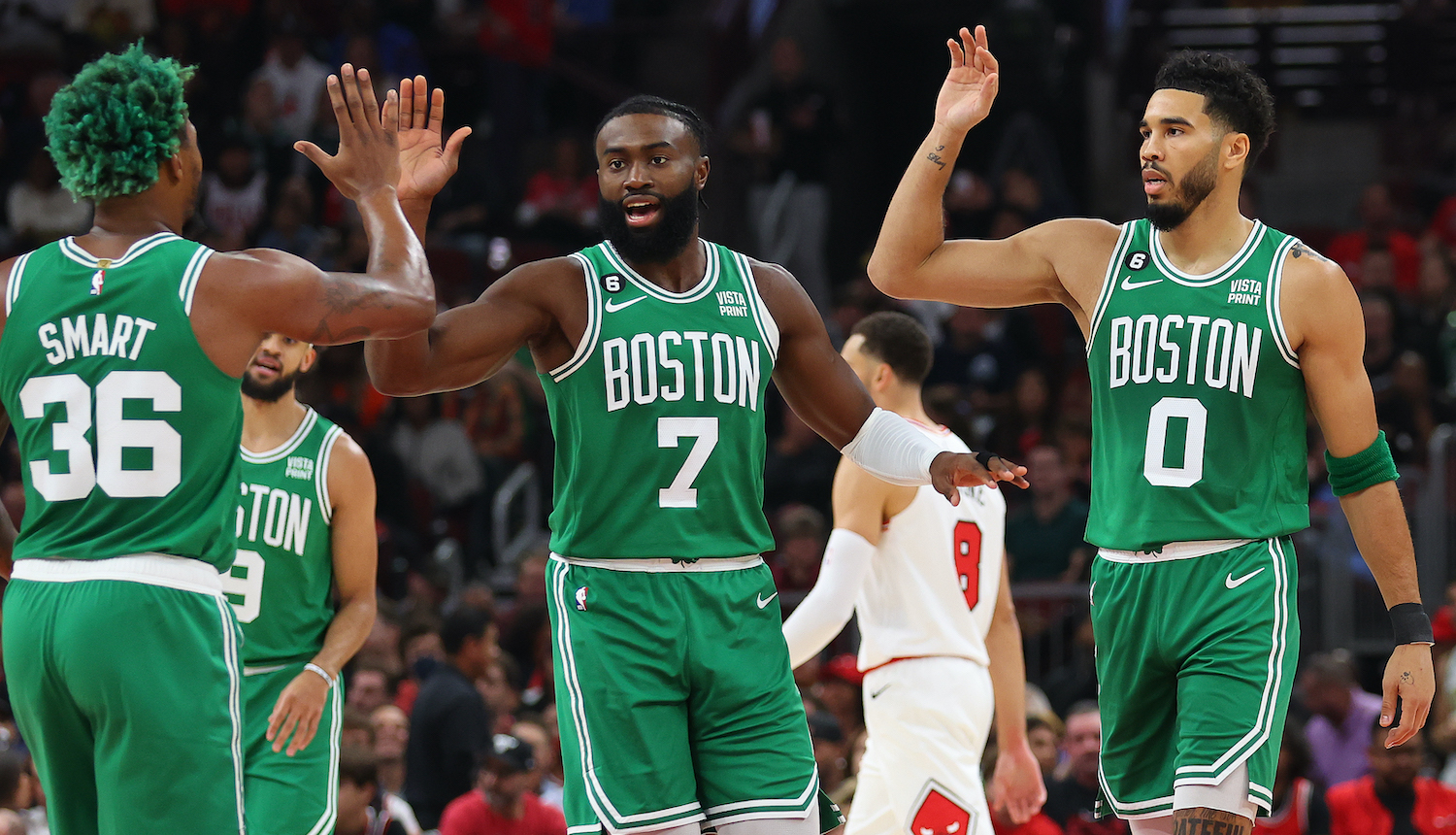 CHICAGO, ILLINOIS - OCTOBER 24: Marcus Smart #36, Jaylen Brown #7 and Jayson Tatum #0 of the Boston Celtics celebrate against the Chicago Bulls during the first half at United Center on October 24, 2022 in Chicago, Illinois. NOTE TO USER: User expressly acknowledges and agrees that, by downloading and or using this photograph, User is consenting to the terms and conditions of the Getty Images License Agreement. (Photo by Michael Reaves/Getty Images)