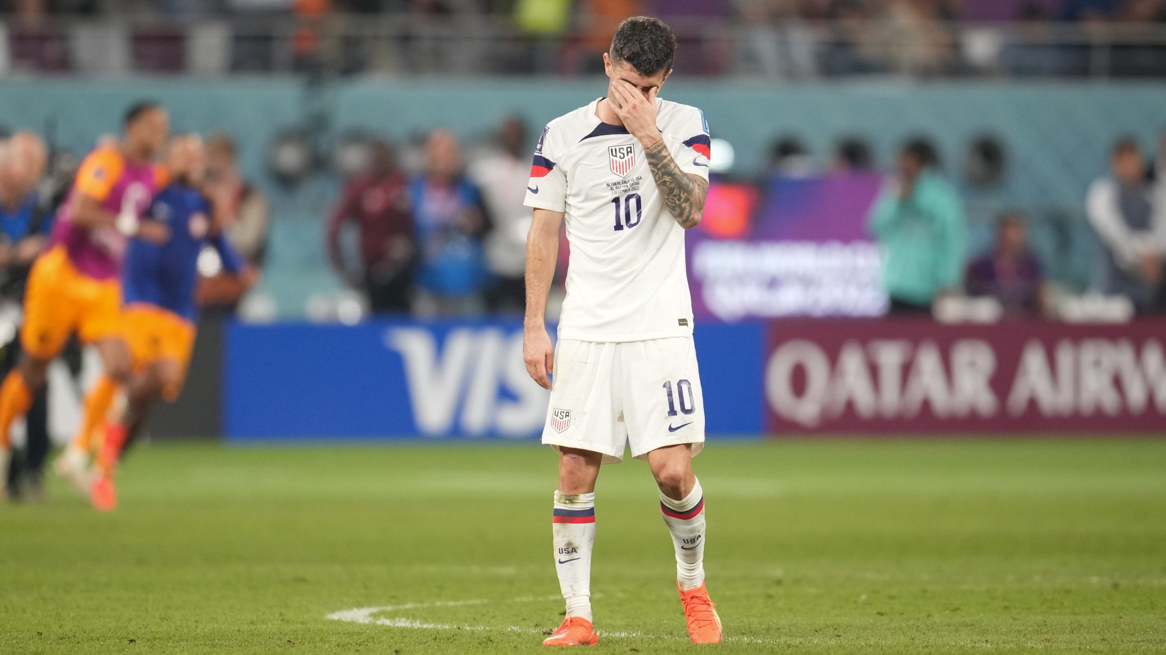 Christian Pulisic #10 of the United States reacts at the final whistle after a FIFA World Cup Qatar 2022 Round of 16 match between Netherlands and USMNT at Khalifa International Stadium on December 3, 2022 in Al Rayyan, Qatar. He's dejected with his head in shirt and the USMNT just got a thorough drubbing.