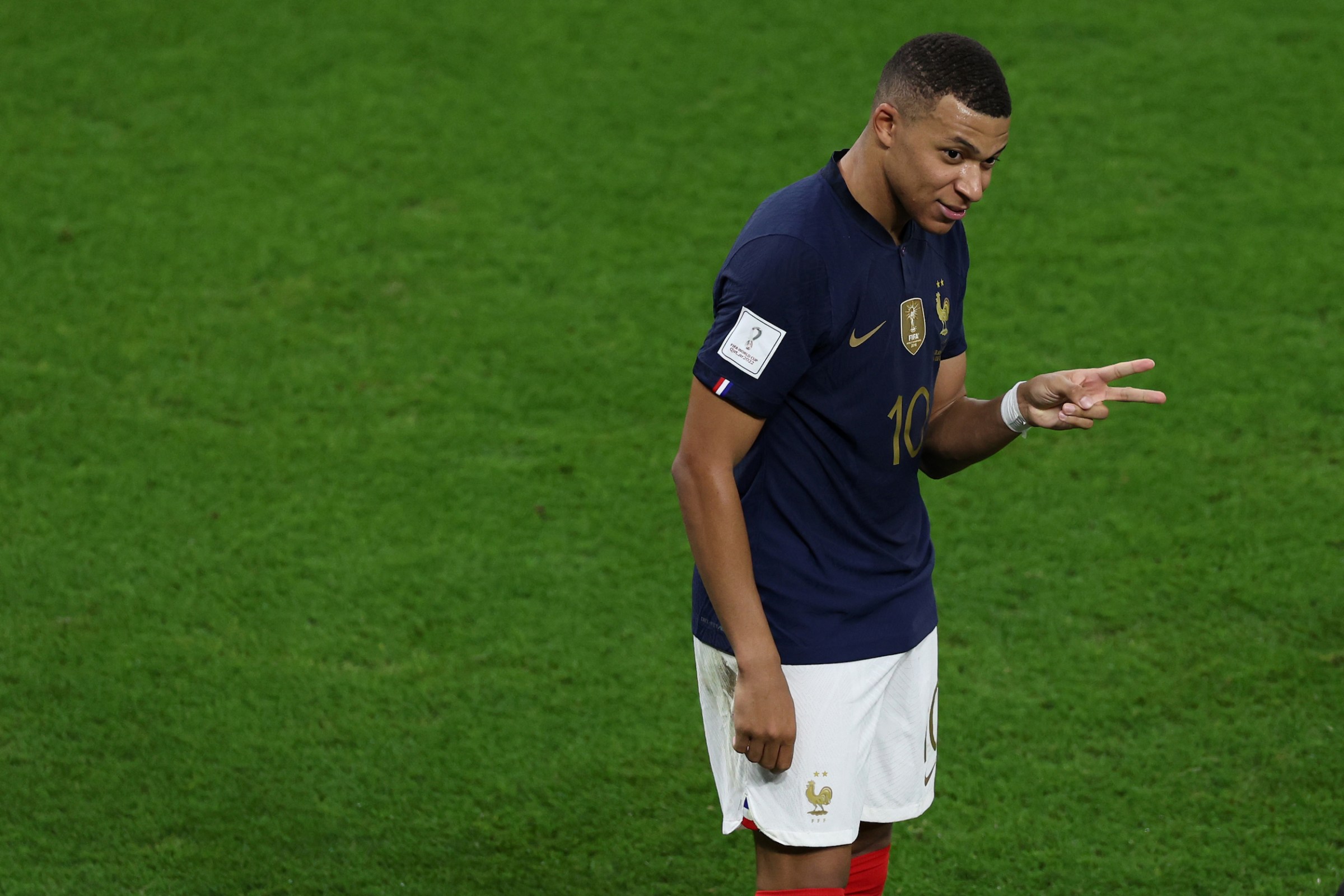 Kylian Mbappé holds up two fingers to signify two goals scored.