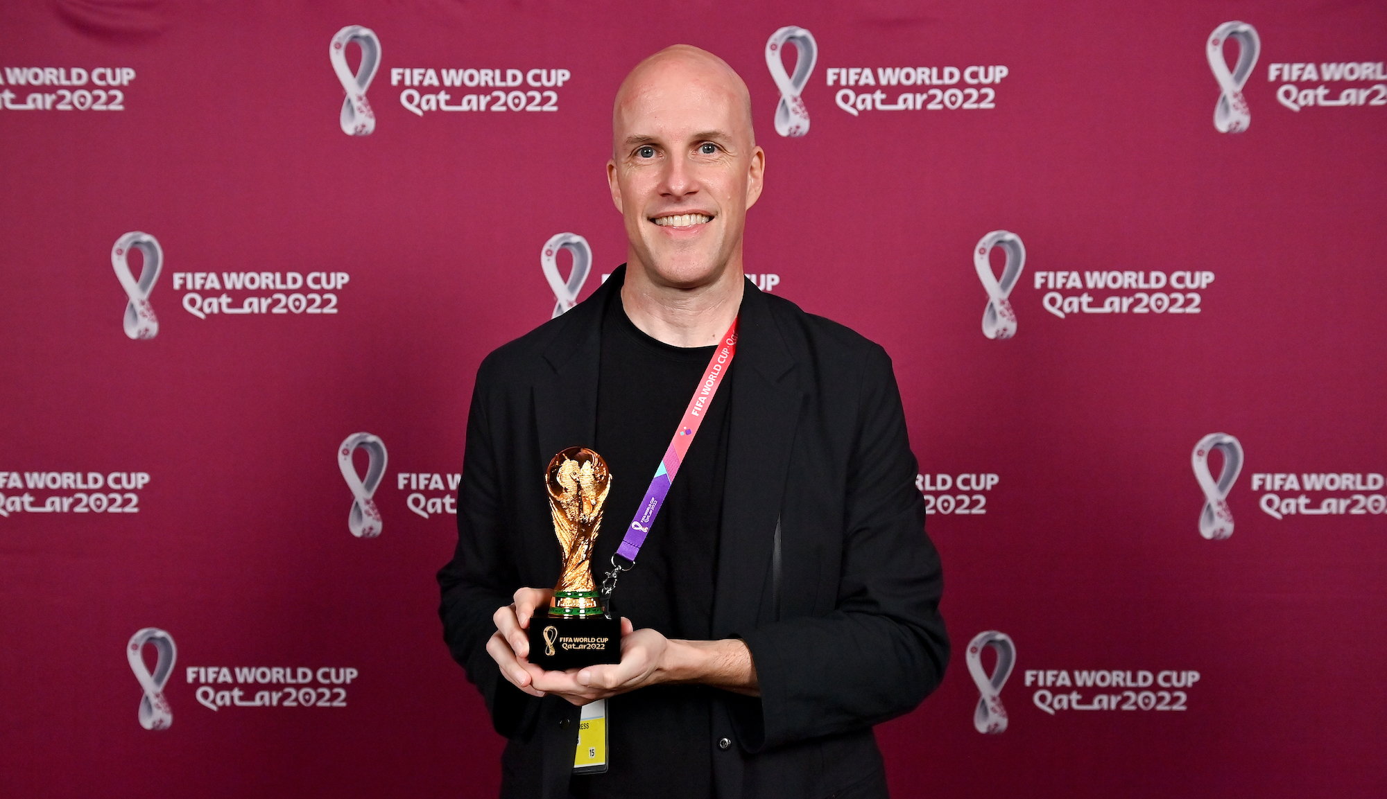 Grant Wahl with a world cup replica trophy, in recognition of their achievement of covering 8 or more FIFA World Cups, during an AIPS / FIFA Journalist on the Podium ceremony at the Main Media Centre on November 29, 2022 in Doha, Qatar.