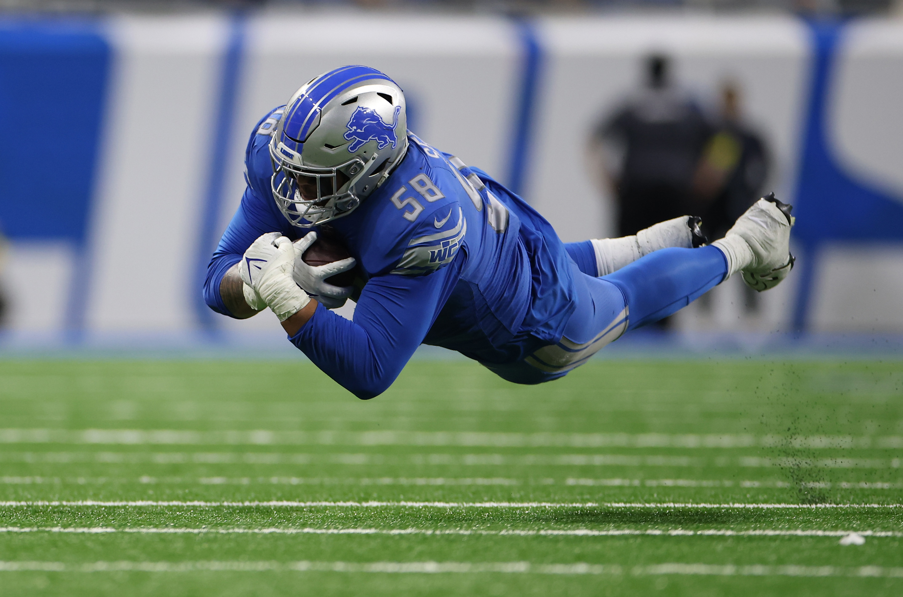 Lions OT Penei Sewell flying fairly gracefully through the air after making a reception against the Vikings in a Detroit win.