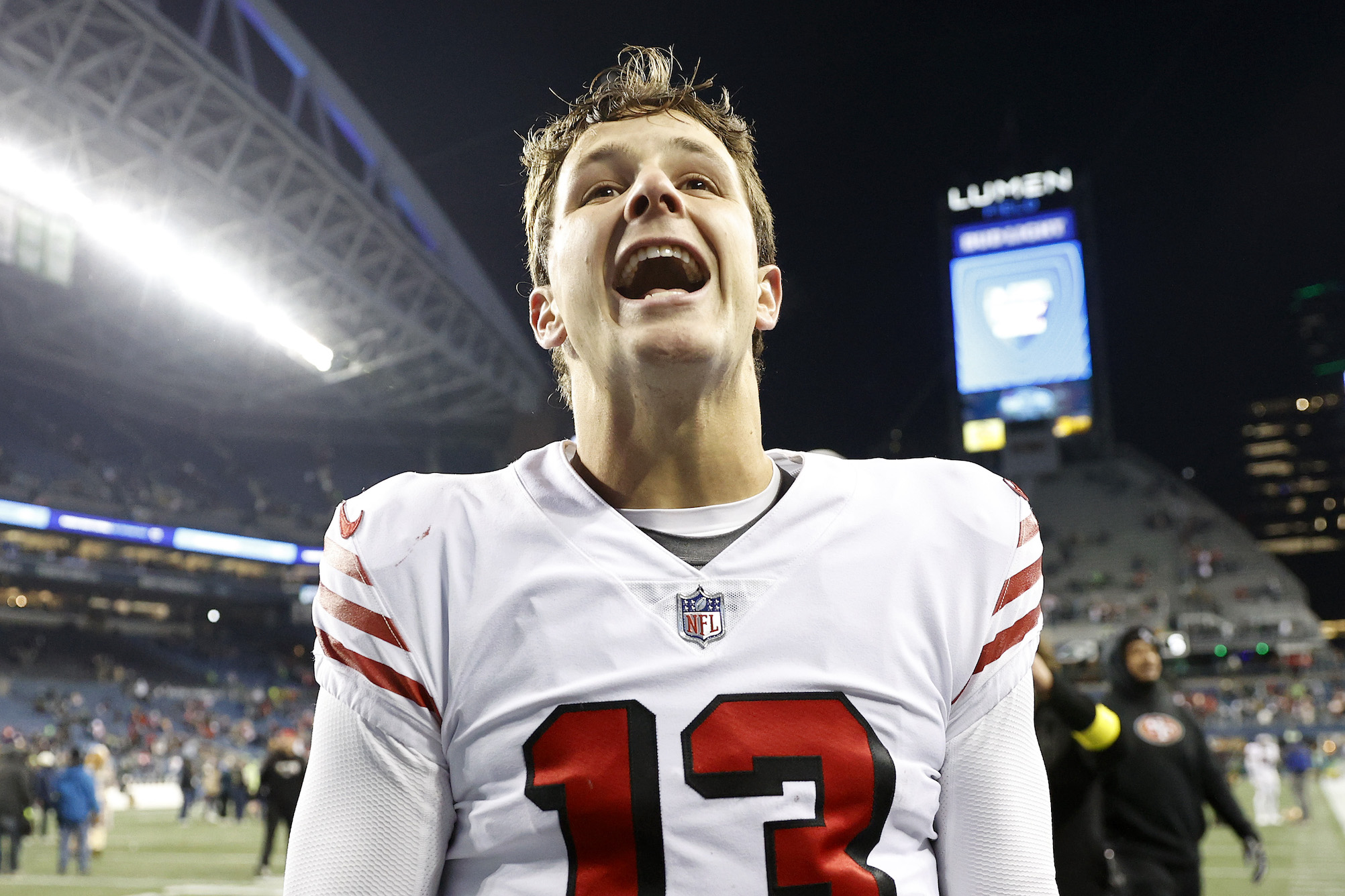 SEATTLE, WASHINGTON - DECEMBER 15: Brock Purdy #13 of the San Francisco 49ers walks off the field after defeating the Seattle Seahawks at Lumen Field on December 15, 2022 in Seattle, Washington. (Photo by Steph Chambers/Getty Images)